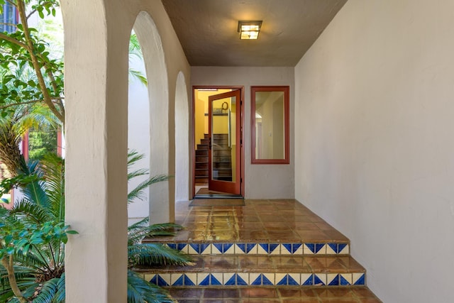 doorway to property featuring stucco siding