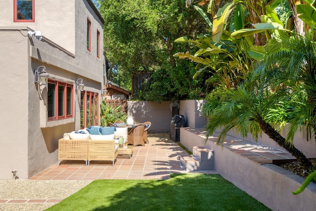 view of patio / terrace featuring an outdoor living space and fence