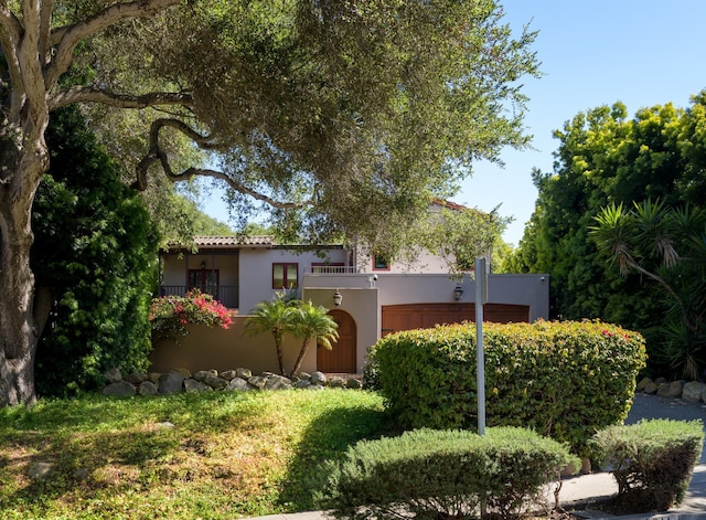 mediterranean / spanish-style home with stucco siding