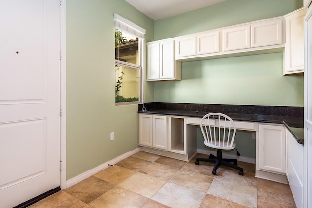 office featuring baseboards and built in desk