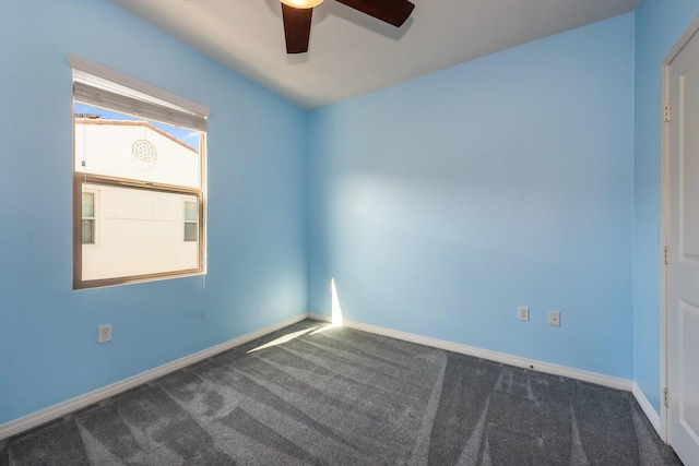 unfurnished room featuring carpet floors, a ceiling fan, and baseboards