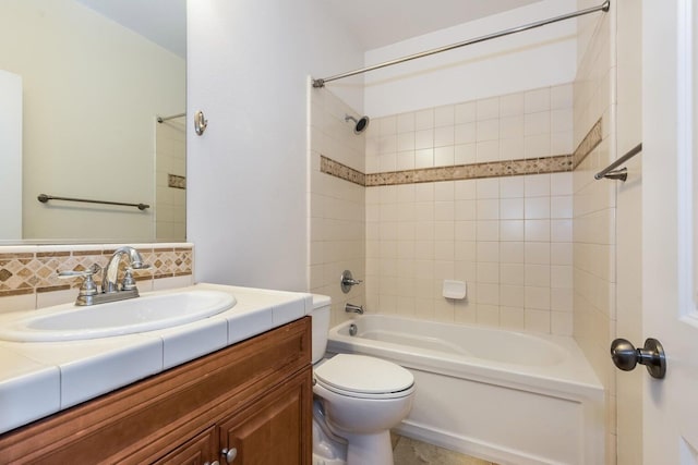 bathroom featuring toilet, shower / bath combination, and vanity
