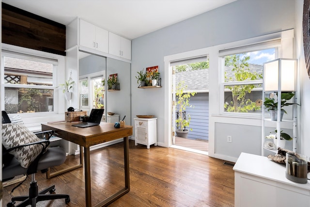 office space featuring baseboards and wood finished floors