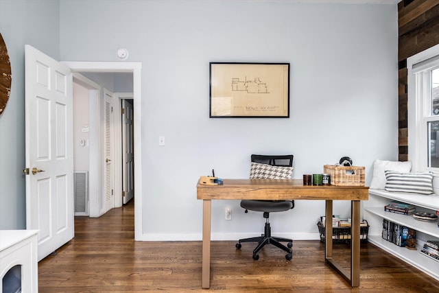 home office with baseboards and wood finished floors