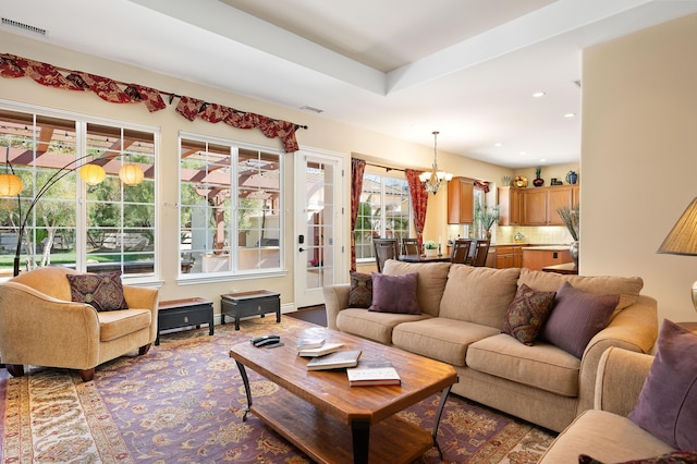 living area featuring recessed lighting, a notable chandelier, and visible vents