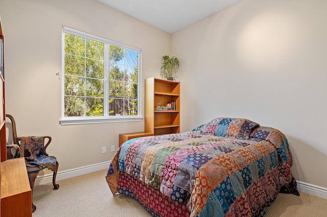 carpeted bedroom with baseboards