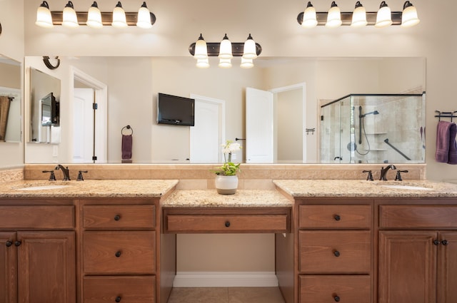 bathroom with two vanities, a shower stall, a sink, and tile patterned flooring