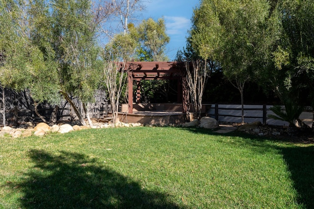 view of yard featuring a pergola and fence