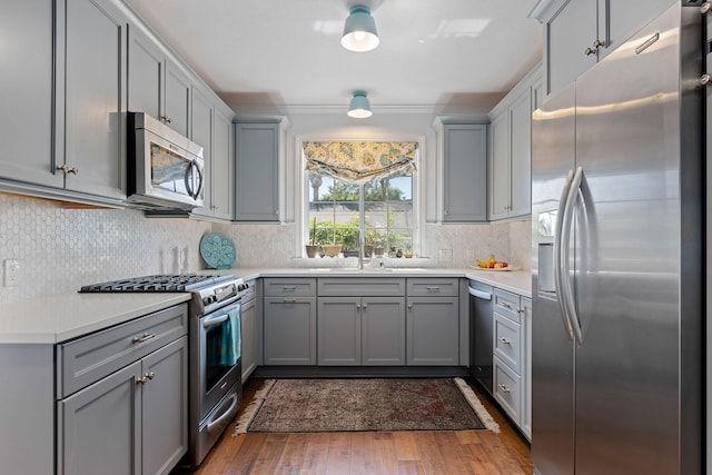 kitchen with light countertops, gray cabinets, and stainless steel appliances