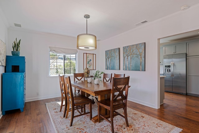 dining area featuring ornamental molding, hardwood / wood-style floors, and visible vents