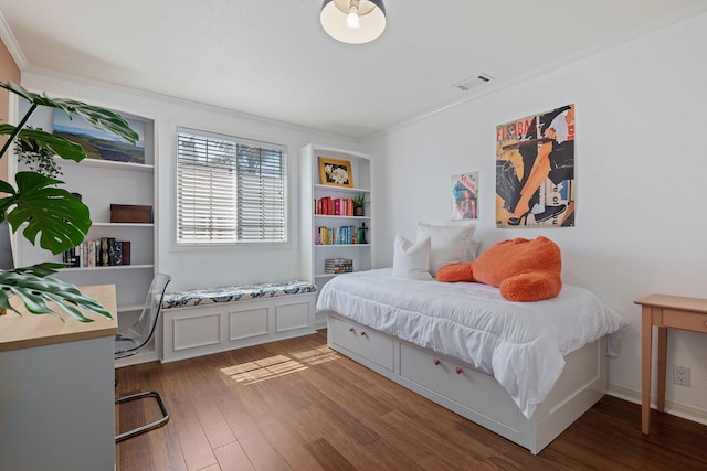 bedroom with ornamental molding, light wood finished floors, and visible vents