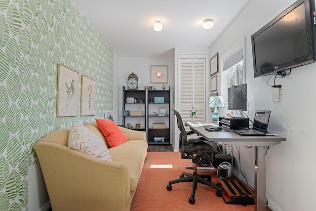 office with baseboards and wallpapered walls