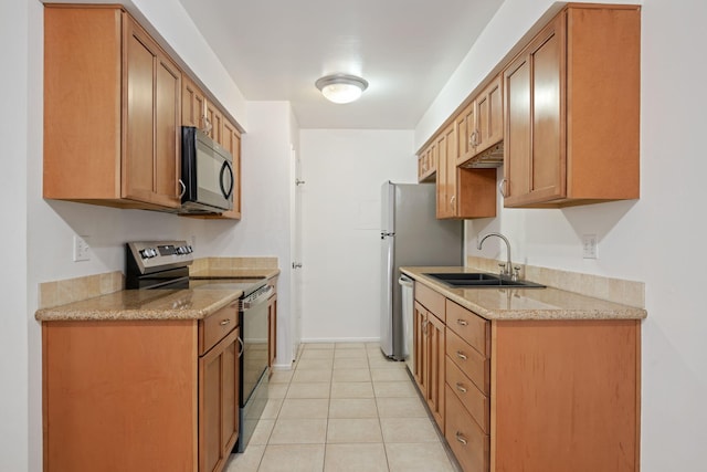 39 Dearborn Pl Unit 95, Goleta, CA 93117 - kitchen with stainless steel appliances, a sink, light tile patterned flooring, baseboards, and brown cabinets