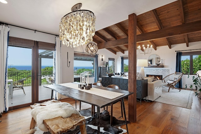 dining room with an inviting chandelier, hardwood / wood-style floors, wooden ceiling, french doors, and lofted ceiling with beams