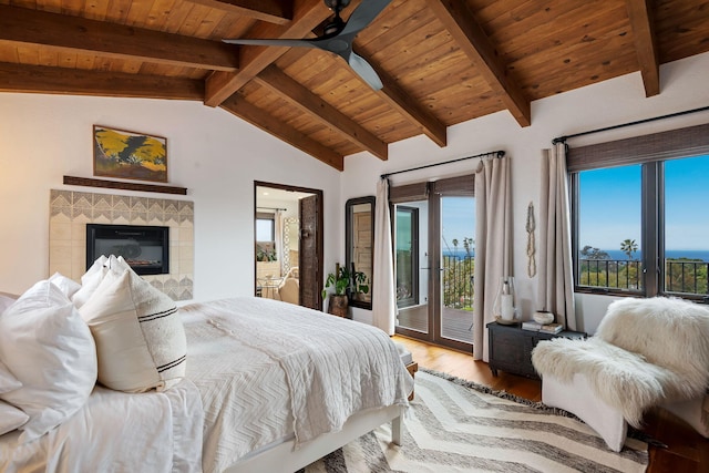bedroom featuring wood ceiling, access to exterior, a tile fireplace, wood finished floors, and lofted ceiling with beams