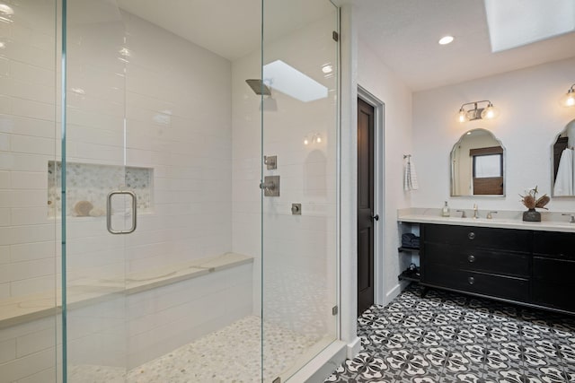 bathroom with recessed lighting, tile patterned floors, tiled shower, and vanity