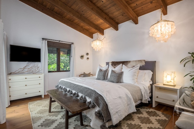 bedroom with wood ceiling, vaulted ceiling with beams, wood finished floors, and a chandelier