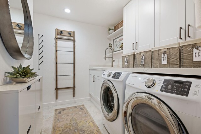 washroom with cabinet space, independent washer and dryer, a sink, recessed lighting, and baseboards