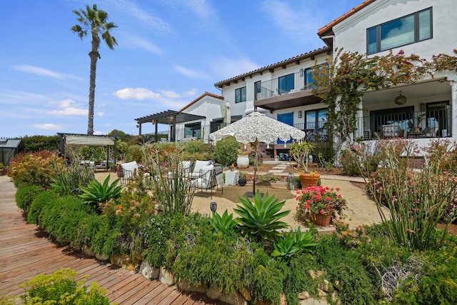 view of home's community featuring a pergola and a patio area