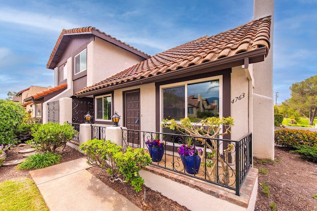 mediterranean / spanish-style home with stucco siding and a tiled roof