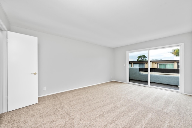 spare room with carpet floors and baseboards