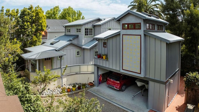 1623 Chapala St, Santa Barbara, CA 93101 - back of property featuring board and batten siding, an attached garage, and driveway