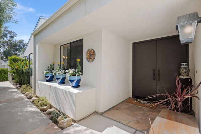 doorway to property with stucco siding