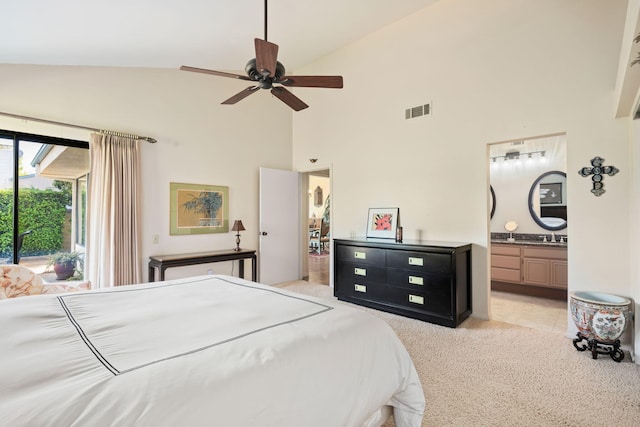 carpeted bedroom with ceiling fan, visible vents, a sink, high vaulted ceiling, and ensuite bathroom