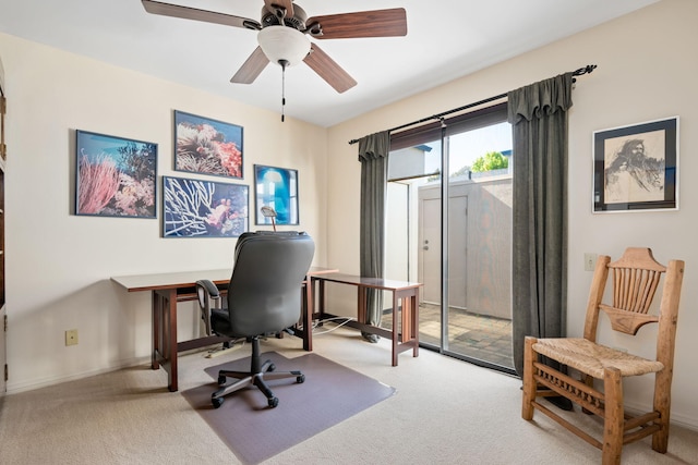 carpeted home office featuring ceiling fan and baseboards