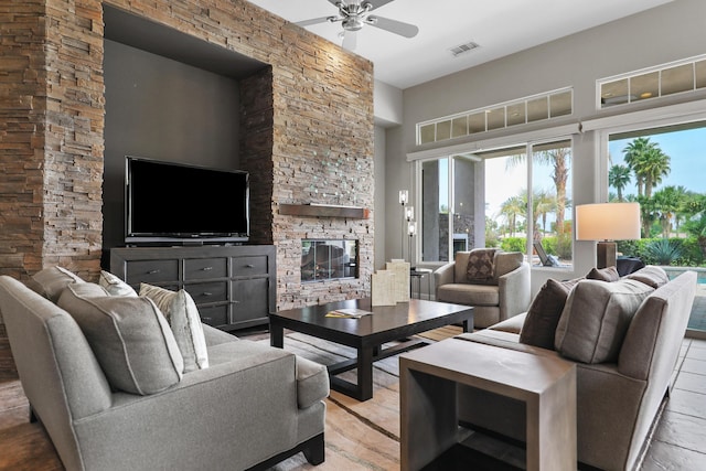 80220 Vía Tesoro, Tesoro, CA 92253 - living area with visible vents, a towering ceiling, ceiling fan, and a fireplace