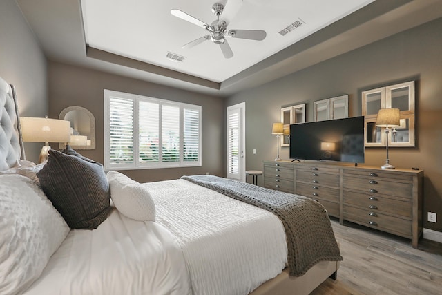 80220 Vía Tesoro, Tesoro, CA 92253 - bedroom featuring visible vents, a raised ceiling, ceiling fan, and wood finished floors