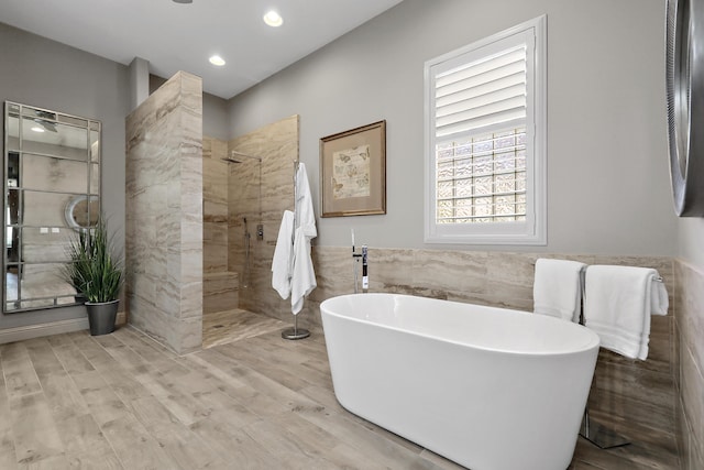 80220 Vía Tesoro, Tesoro, CA 92253 - full bathroom with wood finished floors, tile walls, walk in shower, a wainscoted wall, and a freestanding bath