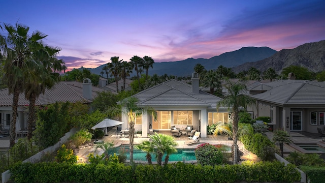 80220 Vía Tesoro, Tesoro, CA 92253 - back of house featuring an outdoor pool, a chimney, an outdoor living space, a patio area, and a tile roof