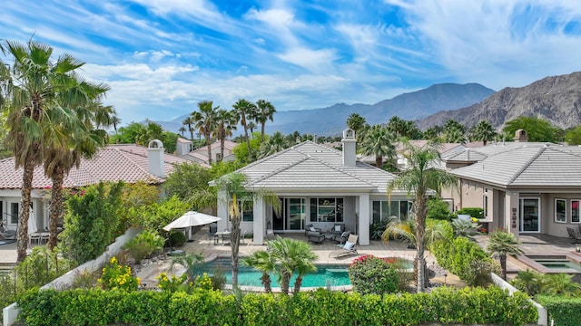 80220 Vía Tesoro, Tesoro, CA 92253 - rear view of property featuring a tiled roof, a chimney, a patio area, and stucco siding