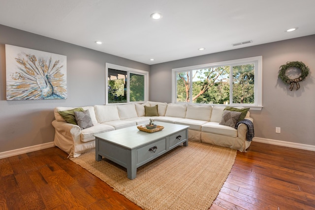 living room featuring baseboards, recessed lighting, hardwood / wood-style floors, and visible vents