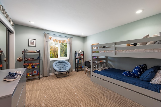 bedroom featuring recessed lighting, baseboards, light colored carpet, and a closet
