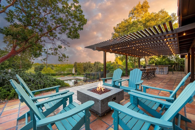 view of patio with outdoor dry bar, a pergola, and a fire pit