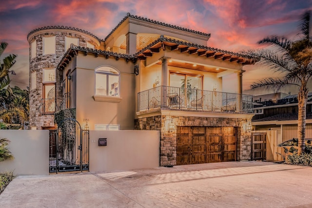 1158 Shelburn Ln, Ventura, CA 93001 - mediterranean / spanish house featuring fence, stone siding, a gate, a balcony, and driveway