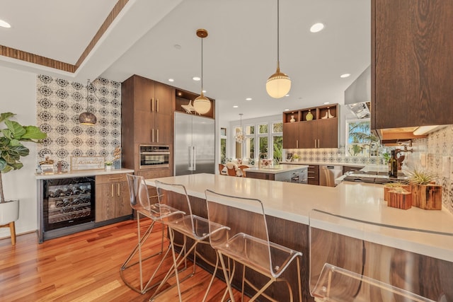 1158 Shelburn Ln, Ventura, CA 93001 - kitchen with open shelves, light countertops, beverage cooler, stainless steel appliances, and decorative backsplash
