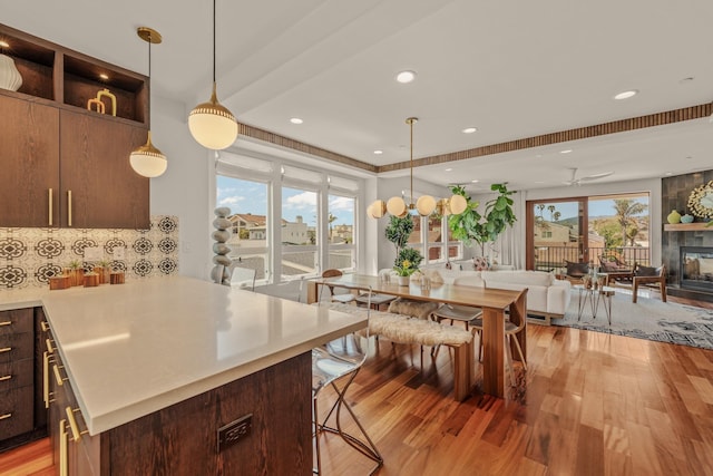 1158 Shelburn Ln, Ventura, CA 93001 - dining room featuring recessed lighting, light wood finished floors, ceiling fan, and a large fireplace