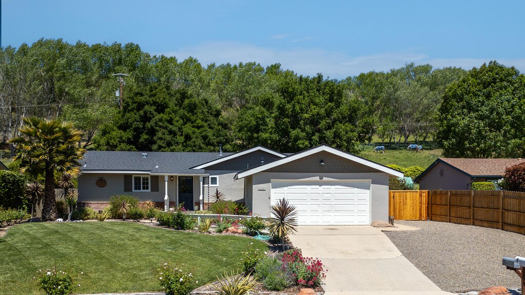 253 Glennora Way, Buellton, CA 93427 - single story home featuring fence, an attached garage, a front yard, a forest view, and driveway