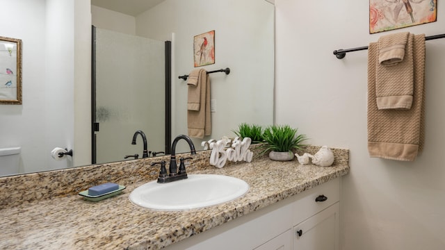 bathroom featuring vanity and an enclosed shower