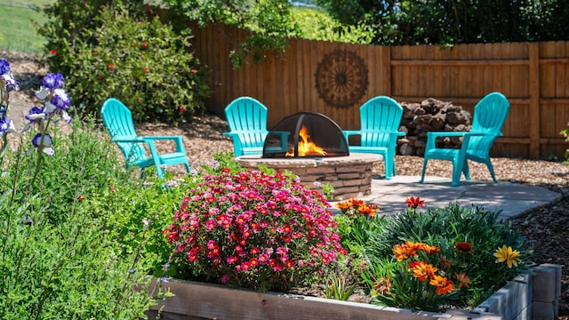 view of patio with fence and a fire pit