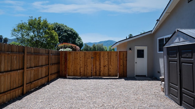 view of patio / terrace with fence and a mountain view