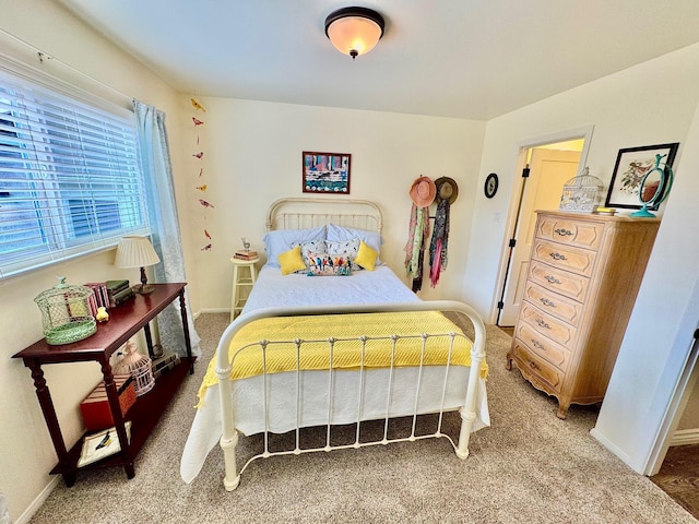 bedroom with carpet floors and baseboards