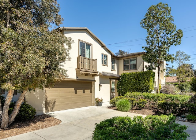 232 Sanderling Ln, Goleta, CA 93117 - view of front facade featuring an attached garage, stucco siding, a balcony, and concrete driveway