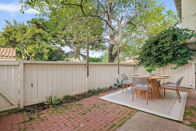 view of patio with a fenced backyard and outdoor dining area