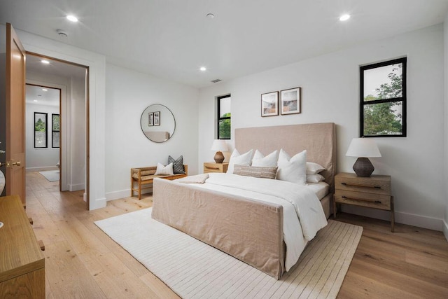 bedroom featuring recessed lighting, light wood-style flooring, baseboards, and visible vents