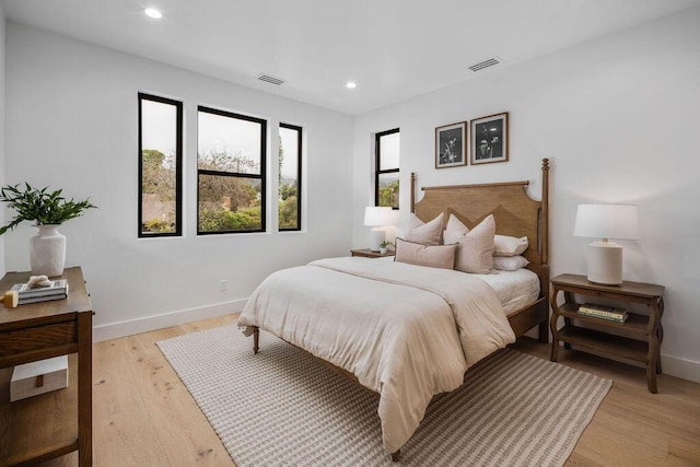 bedroom with visible vents, recessed lighting, baseboards, and light wood-style flooring