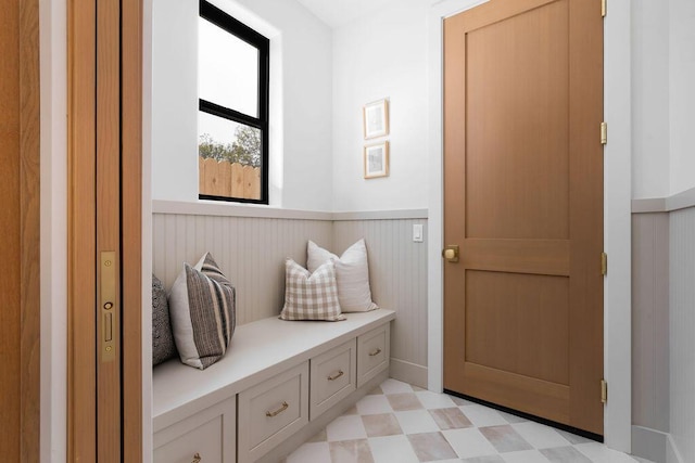 mudroom featuring wainscoting and light floors